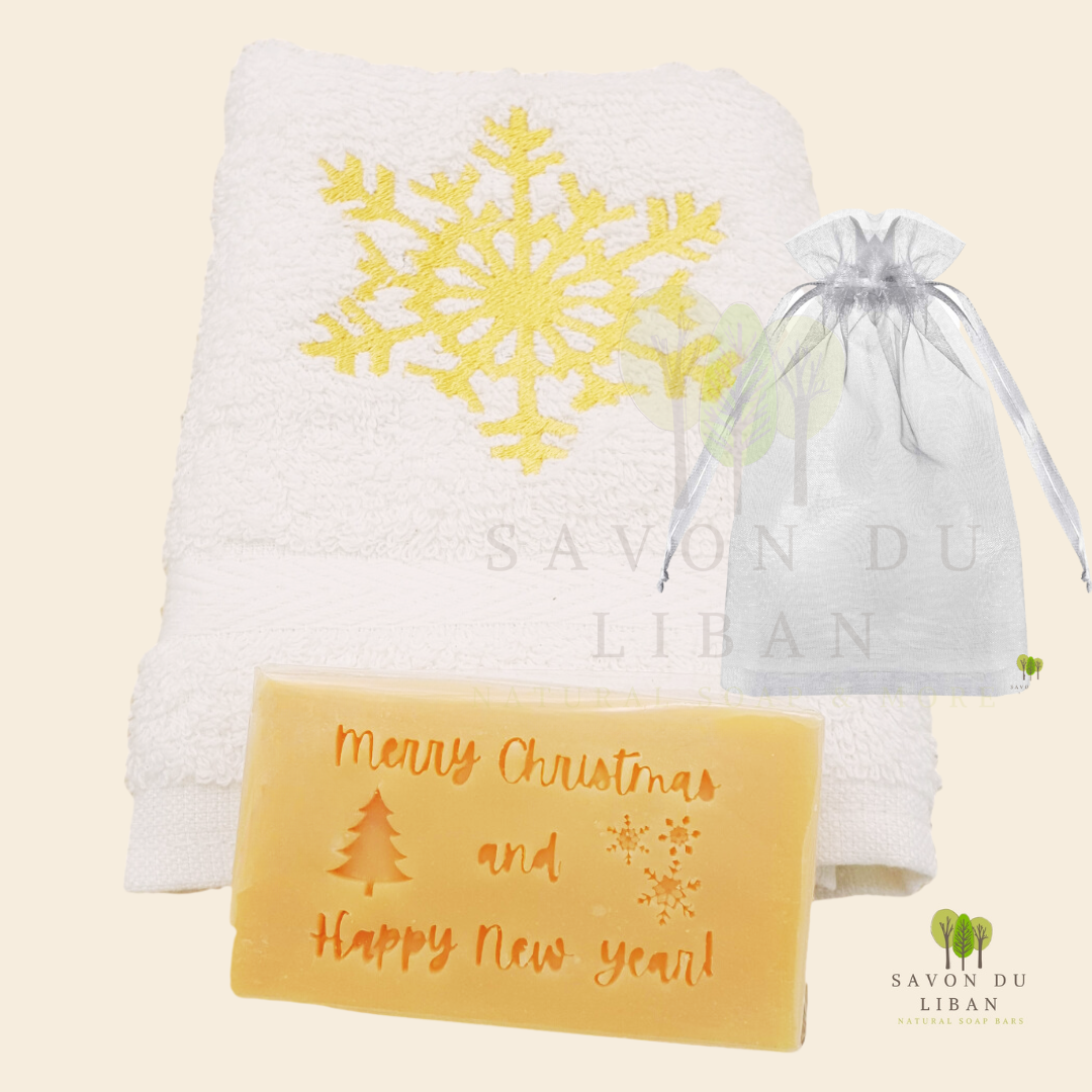 Christmas Cheer in a Bag featuring a festive embroidered towel and musk soap stamped with βMerry Christmas & Happy New Year, in a big organza bag.