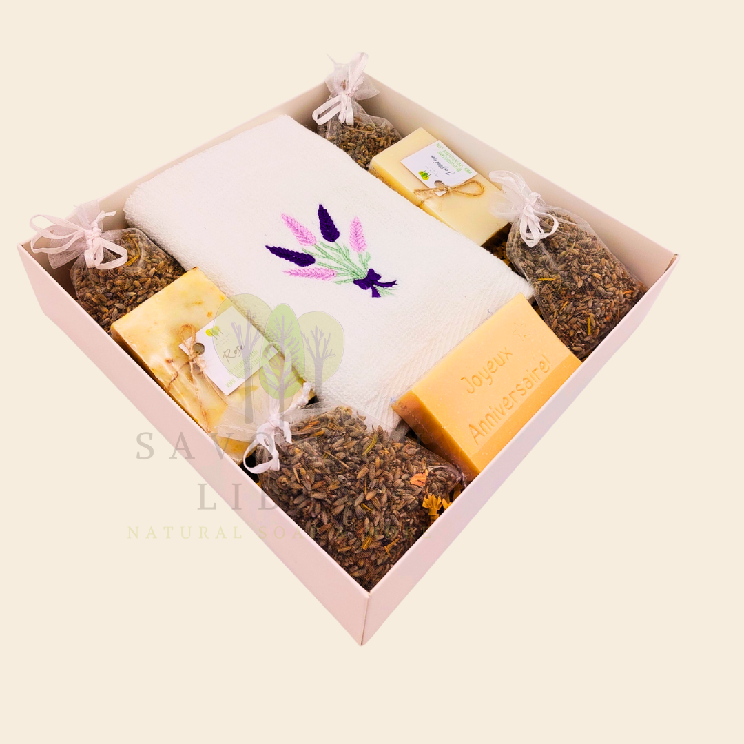 Lavender Moments birthday gift box with lavender towel, soaps, musk engraved bar, and lavender bags in a white box with transparent lid.