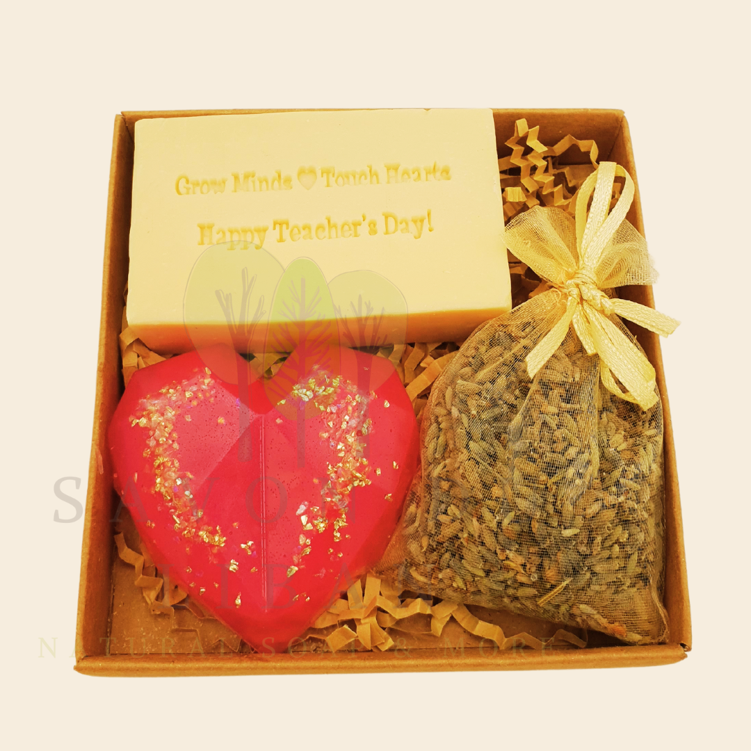 Teacher’s Relax & Enjoy Set – Stamped soap 'Grow Minds ❤️ Touch Hearts - Happy Teacher's Day!', heart soap, and lavender bag in a 11x11x2.5 cm craft box with transparent cover.