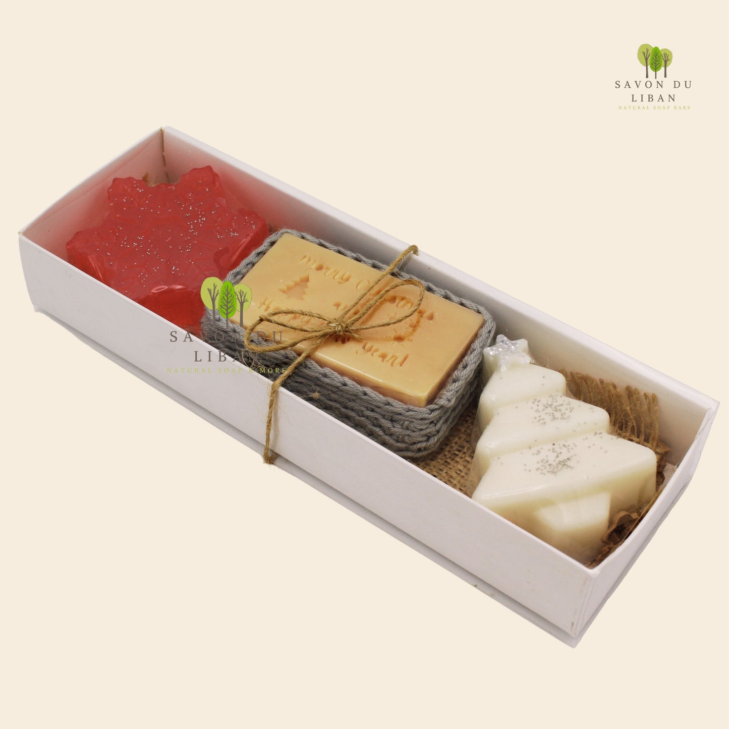 Winter Wishes holiday soap set featuring artisanal Christmas soaps: 1 Snowflake, 1 Tree, 1 Musk soap stamped with Merry Christmas & Happy New Year inside a crochet bag.