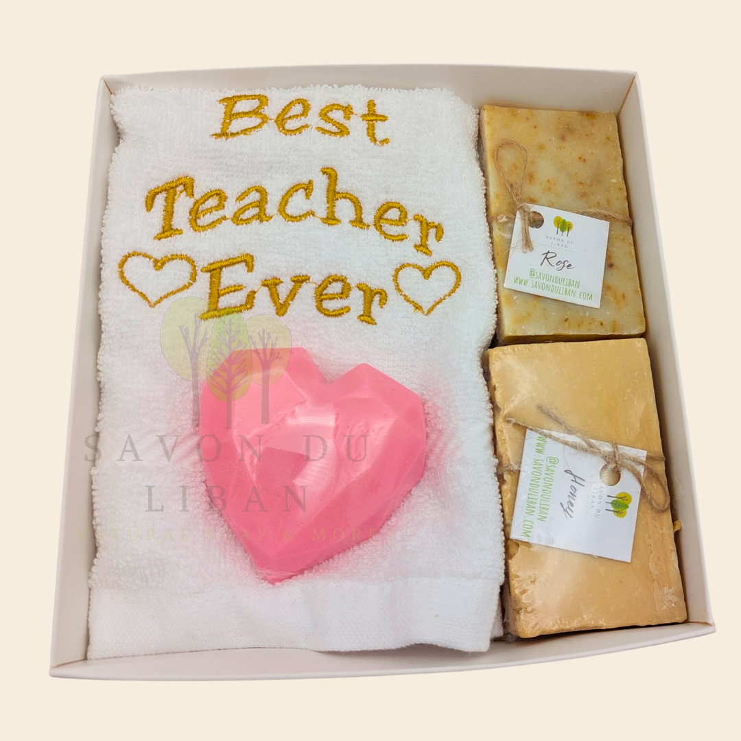 "Teacher's Fabulous Box" gift set with a 30x30 cm towel embroidered with 'Best Teacher Ever' and soaps (including a heart-shaped soap) in a box with a transparent cover. Handmade in Lebanon by Savon Du Liban for Teacher's Day.
