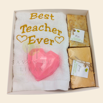 "Teacher's Fabulous Box" gift set with a 30x30 cm towel embroidered with 'Best Teacher Ever' and soaps (including a heart-shaped soap) in a box with a transparent cover. Handmade in Lebanon by Savon Du Liban for Teacher's Day.