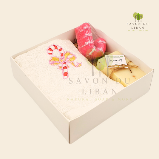 Sugarplum Surprise Gift Box with Festive sugarcane embroidery on a soft facial towel, a sugarcane-shaped soap, and a natural soap bar.