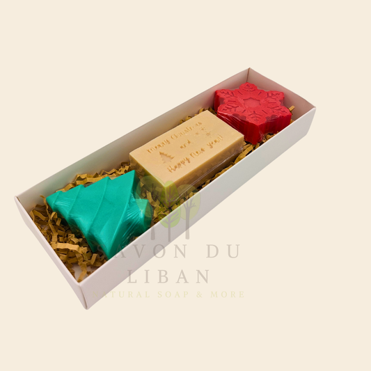 Snowflake, Christmas tree, and engraved musk soap arranged in Trio d’Hiver's white box with transparent cover.