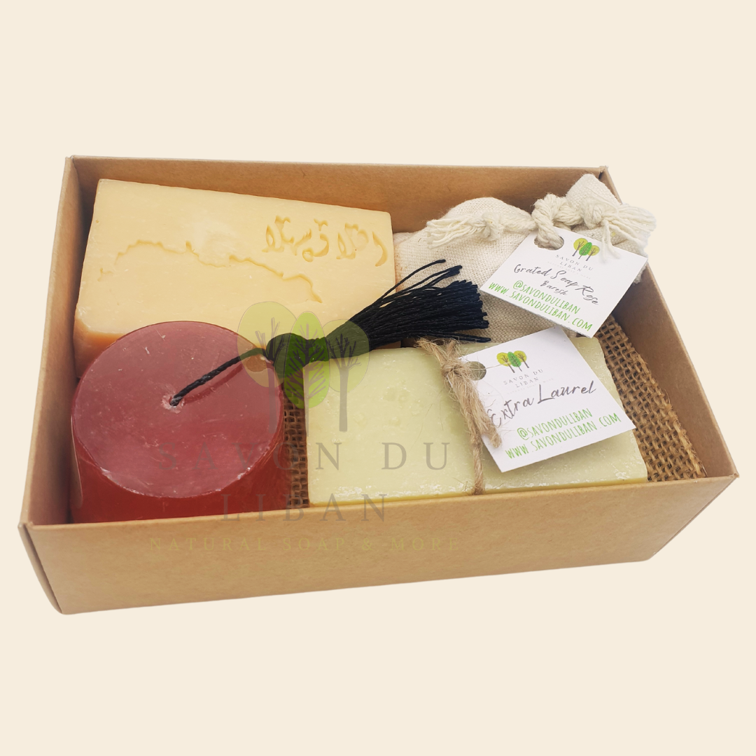 Timeless Charms of Lebanon soap gift set with grated soap, extra laurel soap bar, a tarboosh soap, and a musk soap stamped with Lebanon's Map & Ahla w Sahla in Arabic. Box with open lid.