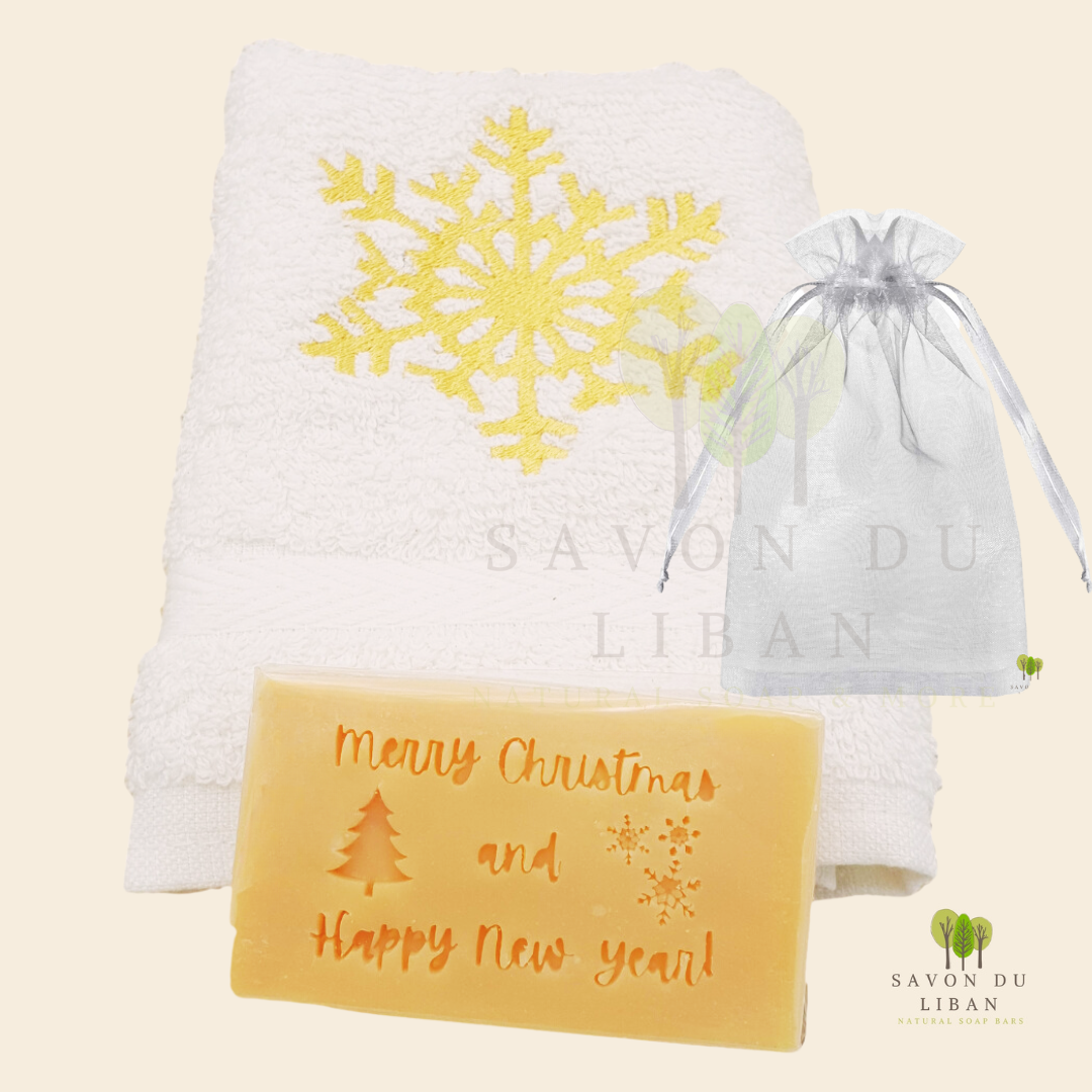 Christmas Cheer in a Bag featuring a festive embroidered towel and musk soap stamped with ‘Merry Christmas & Happy New Year, in a big organza bag.