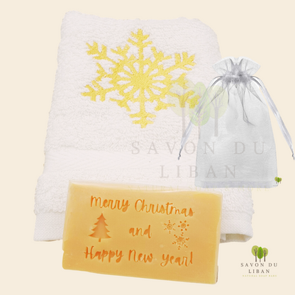 Christmas Cheer in a Bag featuring a festive embroidered towel and musk soap stamped with ‘Merry Christmas & Happy New Year, in a big organza bag.