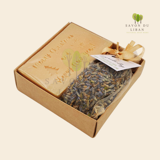 Christmas Serenity Handy Box with musk natural soap engraved with "Merry Christmas & Happy New Year" and lavender sachet, all in a 8x8x2.5 cm kraft box with transparent lid.