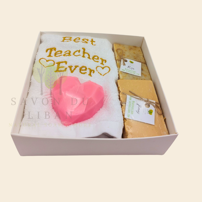 "Teacher's Fabulous Box" gift set with a 30x30 cm towel embroidered with 'Best Teacher Ever' and soaps (including a heart-shaped soap) in a box with a transparent cover. Handmade in Lebanon by Savon Du Liban for Teacher's Day.