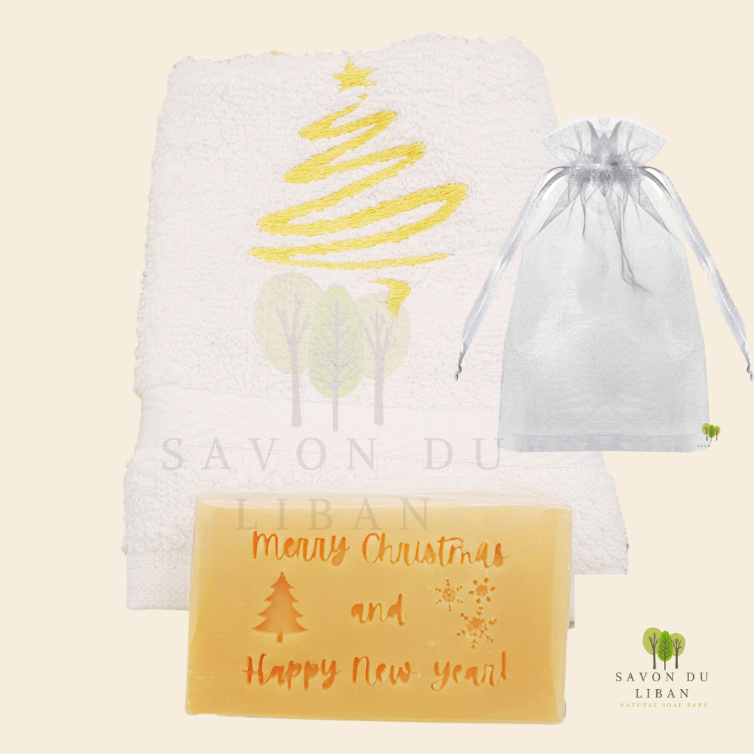 Christmas Cheer in a Bag featuring a festive embroidered towel and musk soap stamped with ‘Merry Christmas & Happy New Year, in a big organza bag.