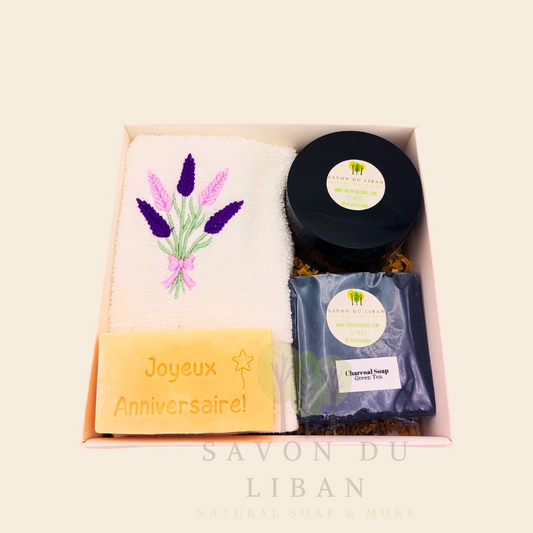 Whispers of Celebration: Birthday gift box with lavender towel, engraved soap, sugar scrub, and charcoal bar. Handmade by Savon Du Liban.