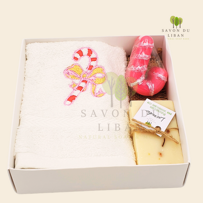 Sugarplum Surprise Gift Box with Festive sugarcane embroidery on a soft facial towel, a sugarcane-shaped soap, and a natural soap bar.