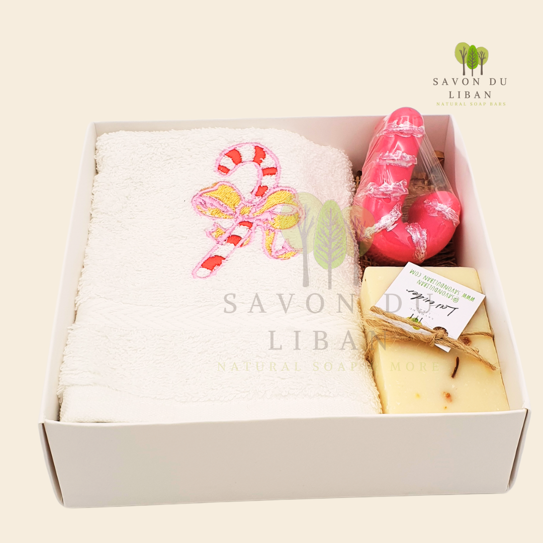 Sugarplum Surprise Gift Box with Festive sugarcane embroidery on a soft facial towel, a sugarcane-shaped soap, and a natural soap bar.