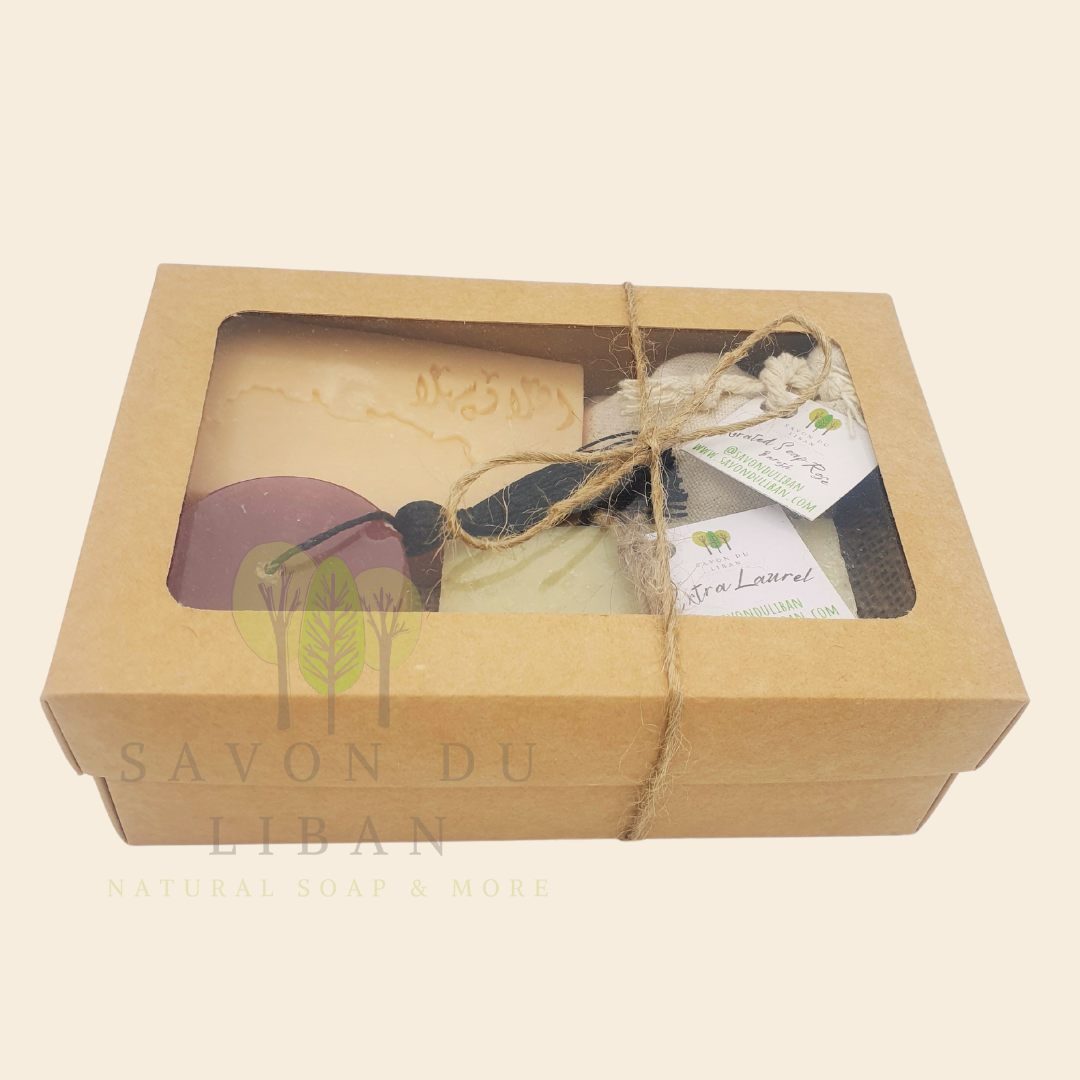 Timeless Charms of Lebanon soap gift set with grated soap, extra laurel soap bar, a tarboosh soap, and a musk soap stamped with Lebanon's Map & Ahla w Sahla in Arabic. Box with closed lid.