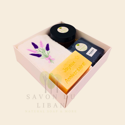 Whispers of Celebration: Birthday gift box with lavender towel, engraved soap, sugar scrub, and charcoal bar. Handmade by Savon Du Liban.
