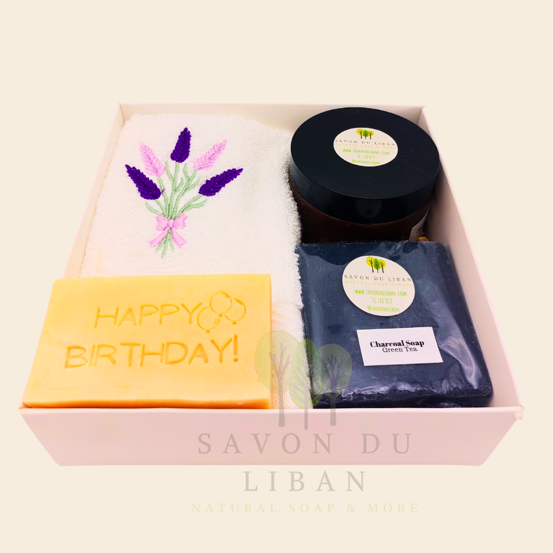 Whispers of Celebration: Birthday gift box with lavender towel, engraved soap, sugar scrub, and charcoal bar. Handmade by Savon Du Liban.