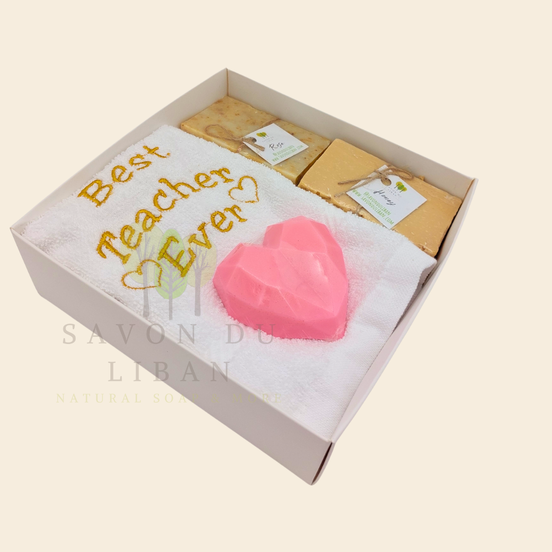 "Teacher's Fabulous Box" gift set with a 30x30 cm towel embroidered with 'Best Teacher Ever' and soaps (including a heart-shaped soap) in a box with a transparent cover. Handmade in Lebanon by Savon Du Liban for Teacher's Day.