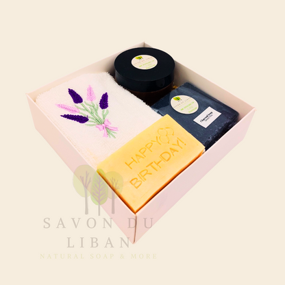 Whispers of Celebration: Birthday gift box with lavender towel, engraved soap, sugar scrub, and charcoal bar. Handmade by Savon Du Liban.