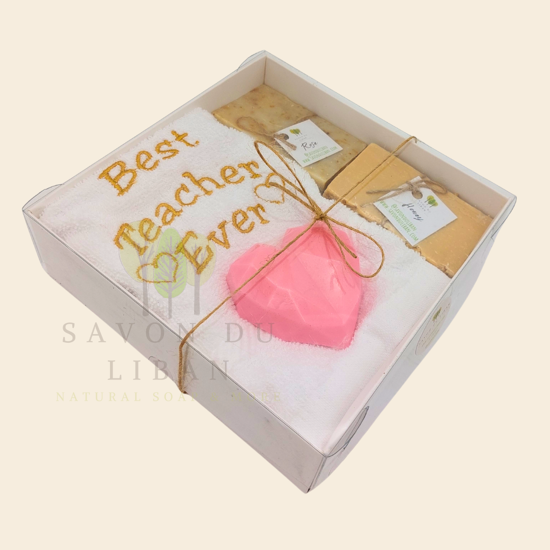 "Teacher's Fabulous Box" gift set with a 30x30 cm towel embroidered with 'Best Teacher Ever' and soaps (including a heart-shaped soap) in a box with a transparent cover. Handmade in Lebanon by Savon Du Liban for Teacher's Day.