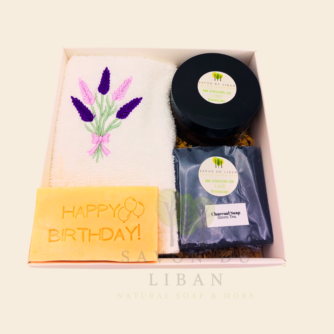 Whispers of Celebration: Birthday gift box with lavender towel, engraved soap, sugar scrub, and charcoal bar. Handmade by Savon Du Liban.