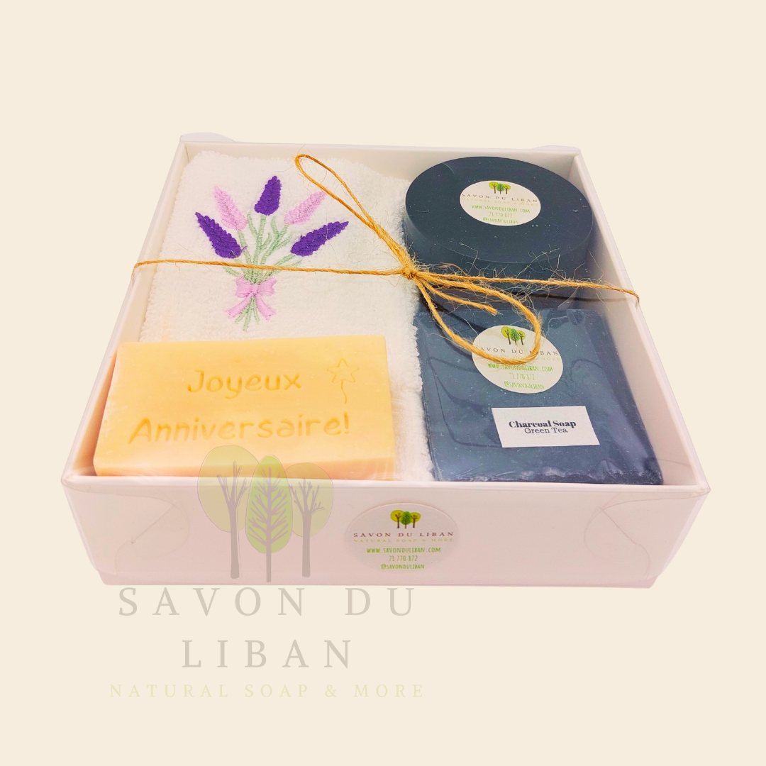 Whispers of Celebration: Birthday gift box with lavender towel, engraved soap, sugar scrub, and charcoal bar. Handmade by Savon Du Liban.