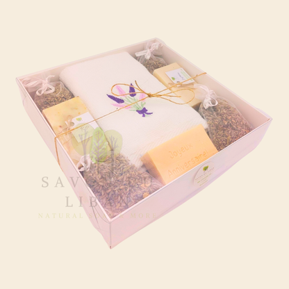 Lavender Moments birthday gift box with lavender towel, soaps, musk engraved bar, and lavender bags in a white box with transparent lid.