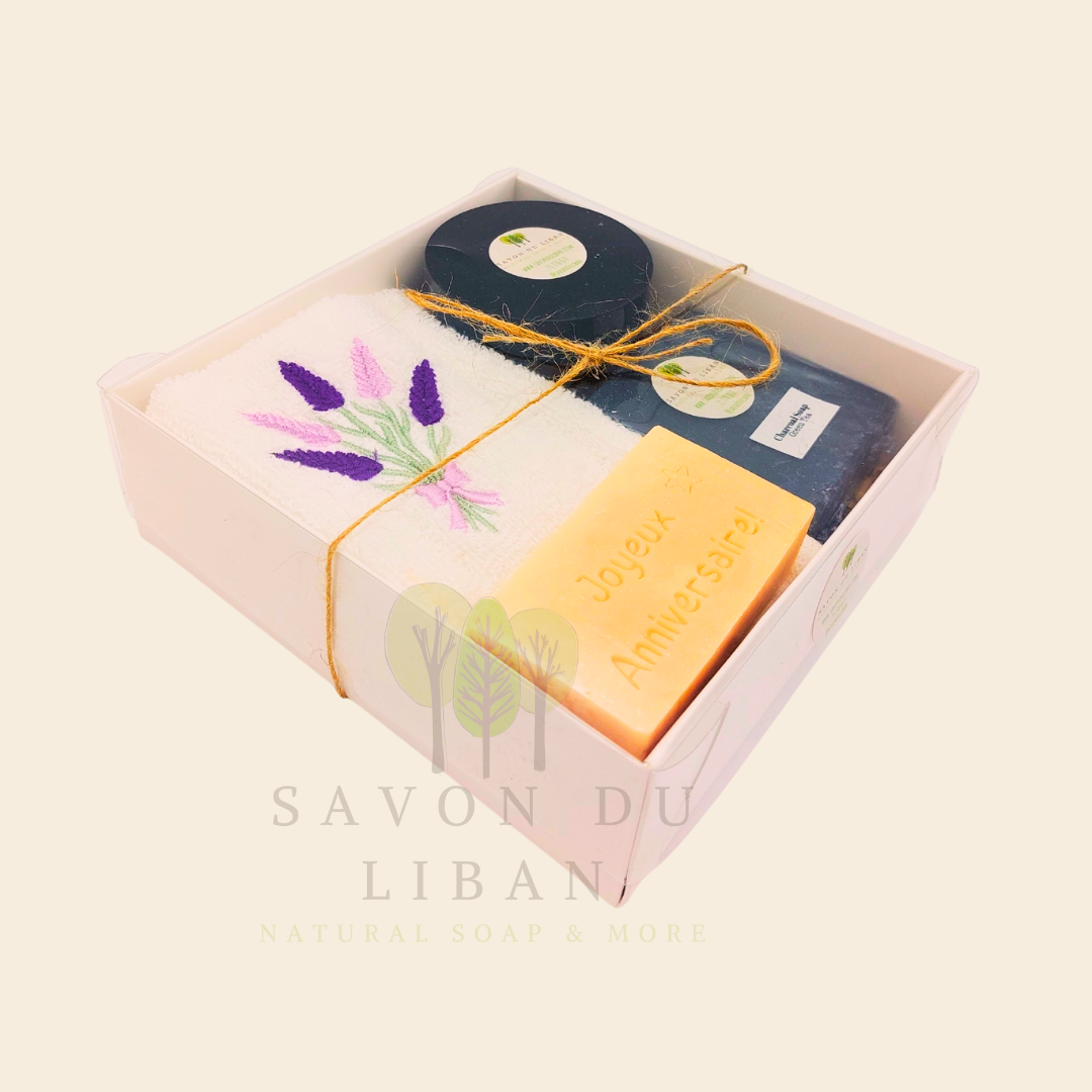 Whispers of Celebration: Birthday gift box with lavender towel, engraved soap, sugar scrub, and charcoal bar. Handmade by Savon Du Liban.