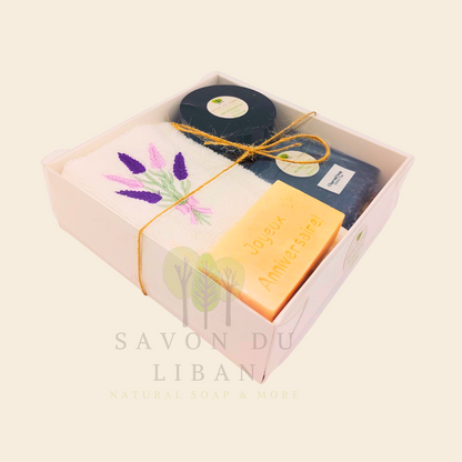 Whispers of Celebration: Birthday gift box with lavender towel, engraved soap, sugar scrub, and charcoal bar. Handmade by Savon Du Liban.
