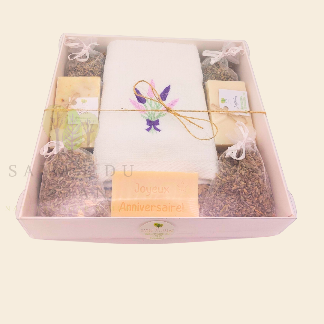 Lavender Moments birthday gift box with lavender towel, soaps, musk engraved bar, and lavender bags in a white box with transparent lid.