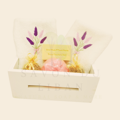 Blooming Minds Gift Basket, a wooden basket (20x12x9 cm) with 2 lavender-embroidered towels, a flower soap, a musk soap stamped with “Grow Minds ❤️ Touch Hearts - Happy Teacher's Day!” and 2 lavender buds bags.