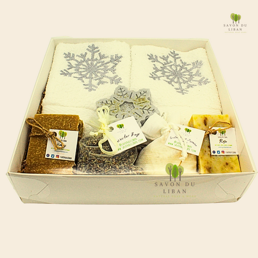 Frosty Forest Christmas gift box with silver-tone towels embroidered with snowflakes, 2 bars of soap, a snowflake soap, a grated soap bag, and lavender bag.