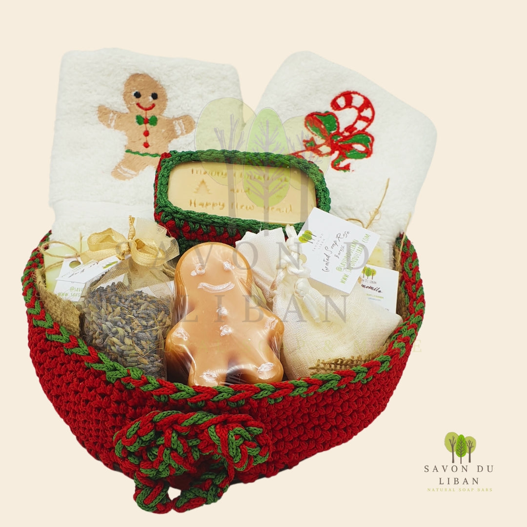 Ginger-fied Crochet Basket with festive embroidered towels and holiday-themed soaps (Gingerbread man-shaped soap).