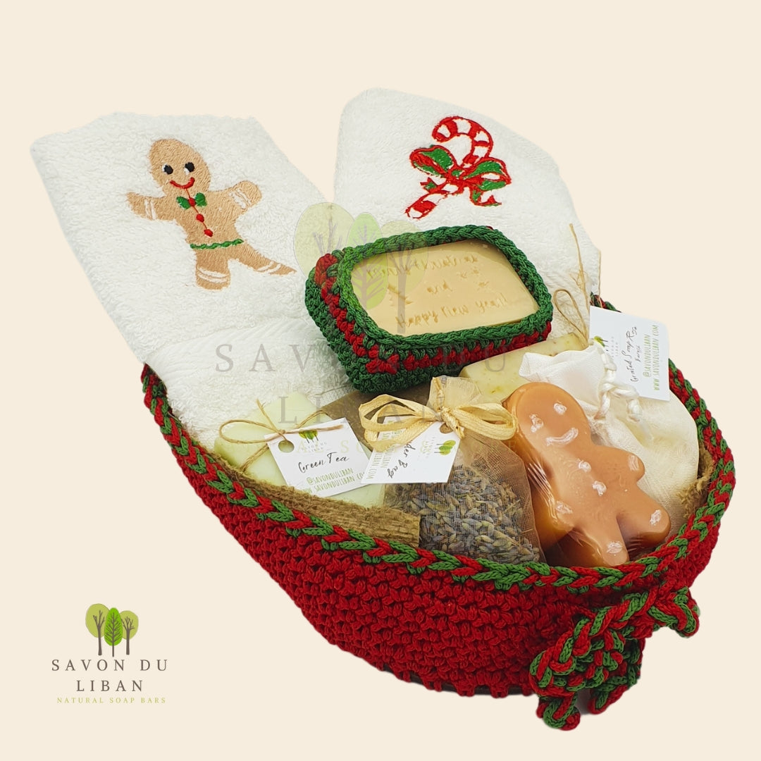 Ginger-fied Crochet Basket with festive embroidered towels and holiday-themed soaps (Gingerbread man-shaped soap).