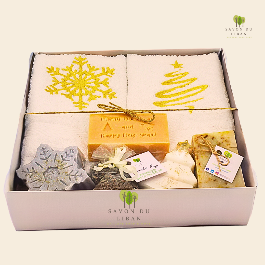 Golden Glow gift set with gold-embroidered towels, festive snowflake & tree soaps, a musk soap engraved with Merry Christmas & Happy New Year, and lavender bag