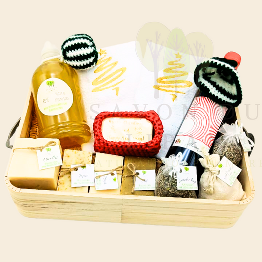 Musar & Musk Christmas Basket with soap bars, red wine, towels, and liquid soap dispenser.