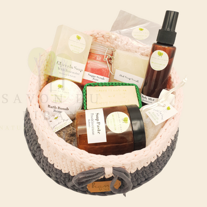 Santa's Indulgence Basket, a crochet basket featuring bath bomb, sugar scrub, glycerin soap, body mist, oat scrub soap, soap paste and much more.