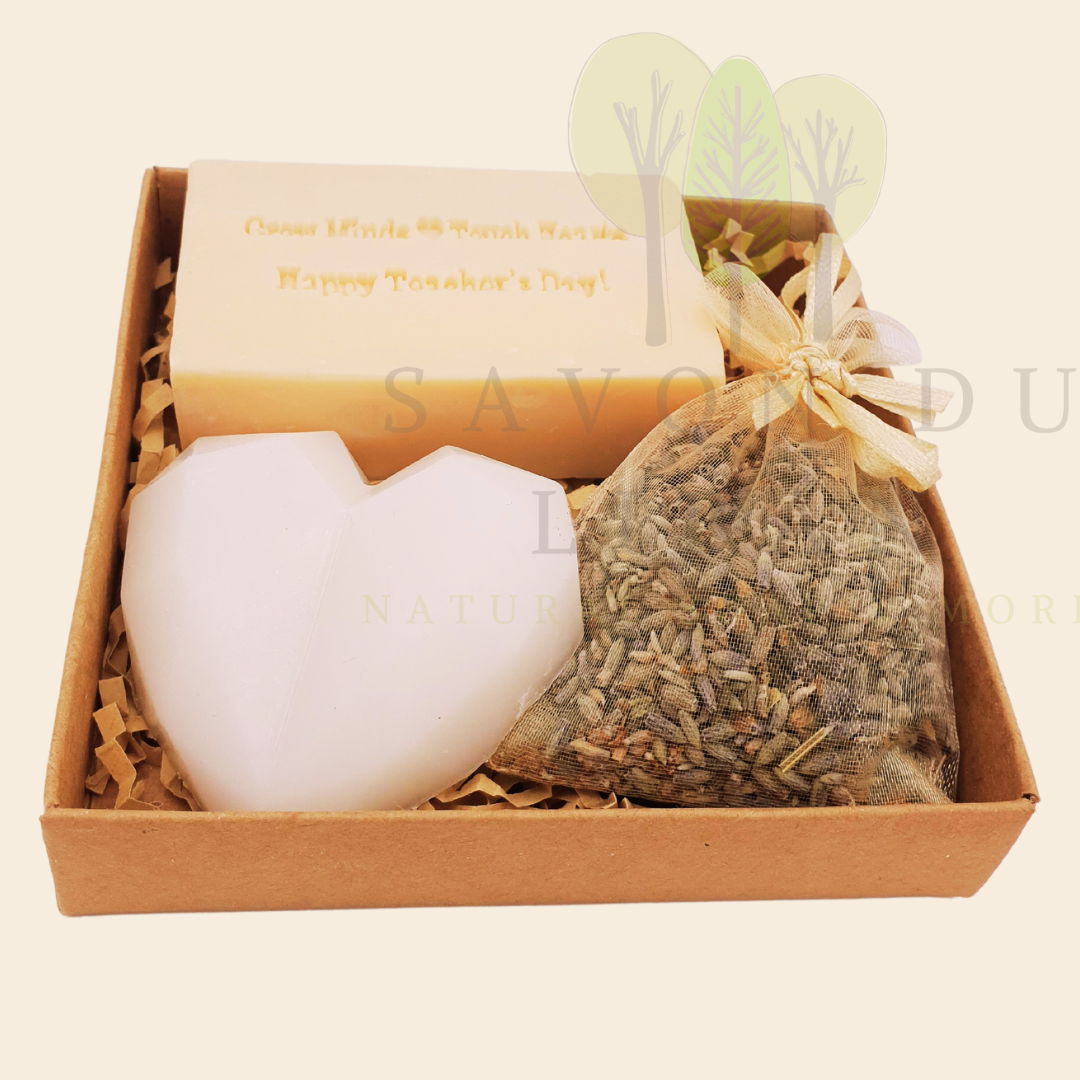 Teacher’s Relax & Enjoy Set – Stamped soap 'Grow Minds ❤️ Touch Hearts - Happy Teacher's Day!', heart soap, and lavender bag in a 11x11x2.5 cm craft box with transparent cover.