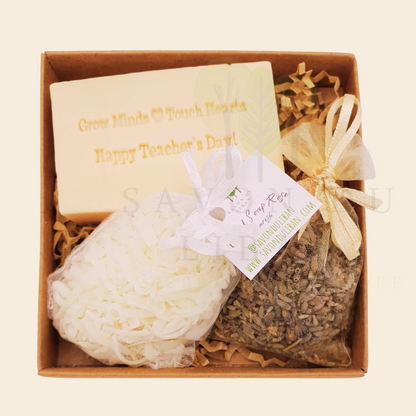 Teacher's Scented Box – Grated soap bag with lavender buds along with musk soap engraved 'Grow Minds ❤️ Touch Hearts - Happy Teacher's Day!' in an elegant 11x11x2.5 cm box with transparent cover.